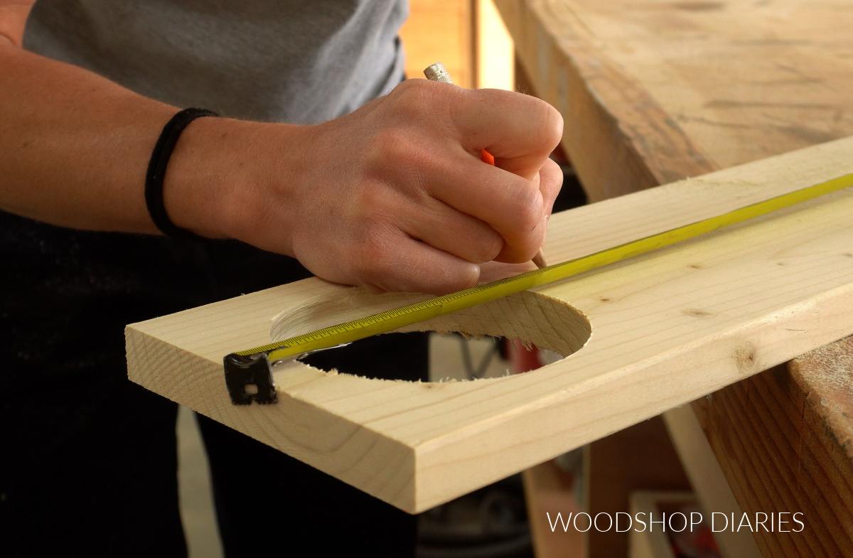 Close up of marking where to cut pieces to make cup holder