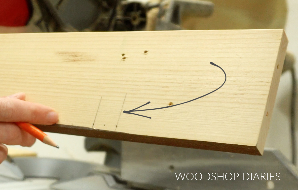 Close up of scrap 1x4 board with marks for cross trivet notches