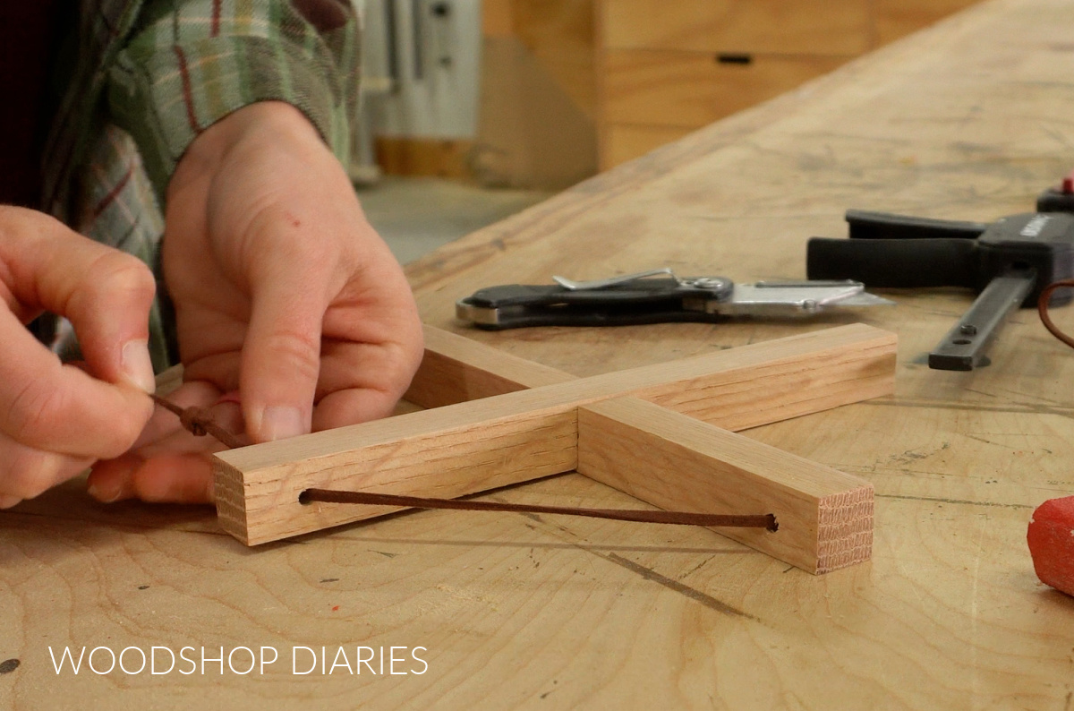 Shara Woodshop Diaries tying leather cord through holes on trivet pieces