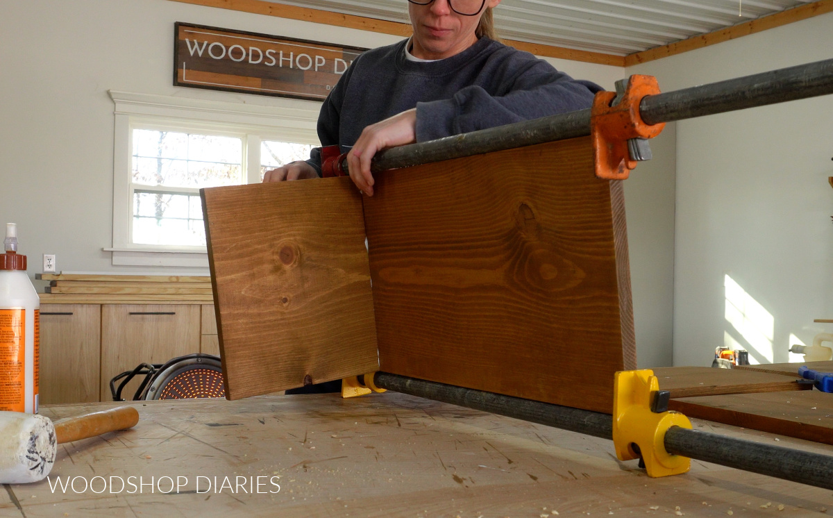 Shara Woodshop Diaries clamping two boards into "T" shaped pieces for angled bookshelf