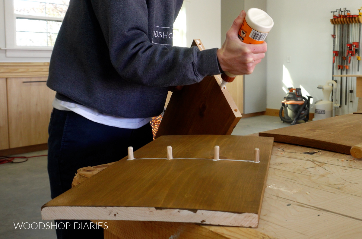 Shara Woodshop Diaries applying wood glue to assemble project with dowels