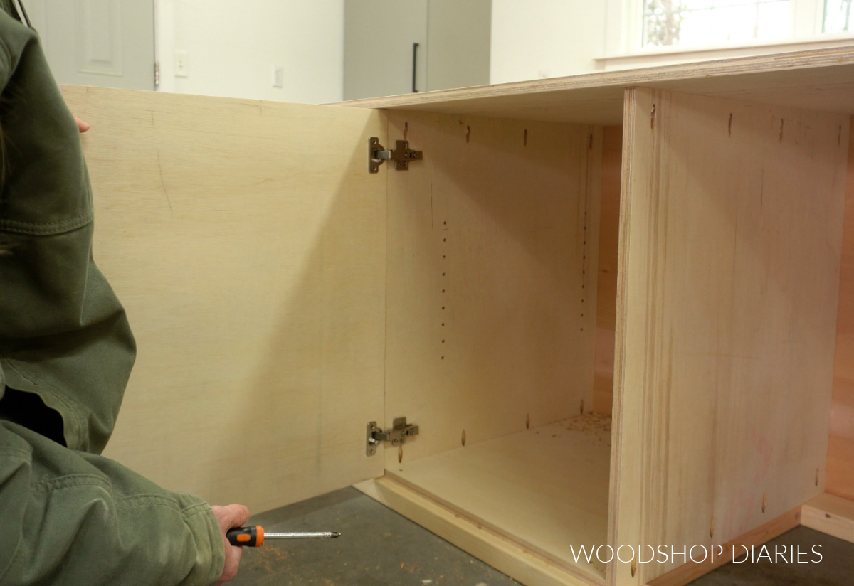 Door installed onto mobile miter saw stand with concealed hinges