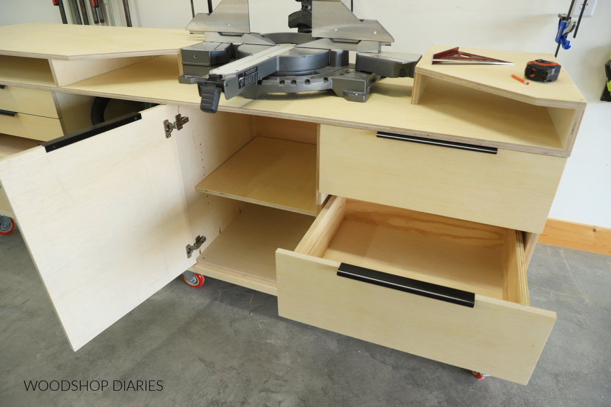 Close up of miter saw stand door open to reveal shelf inside and deep drawer open to show storage