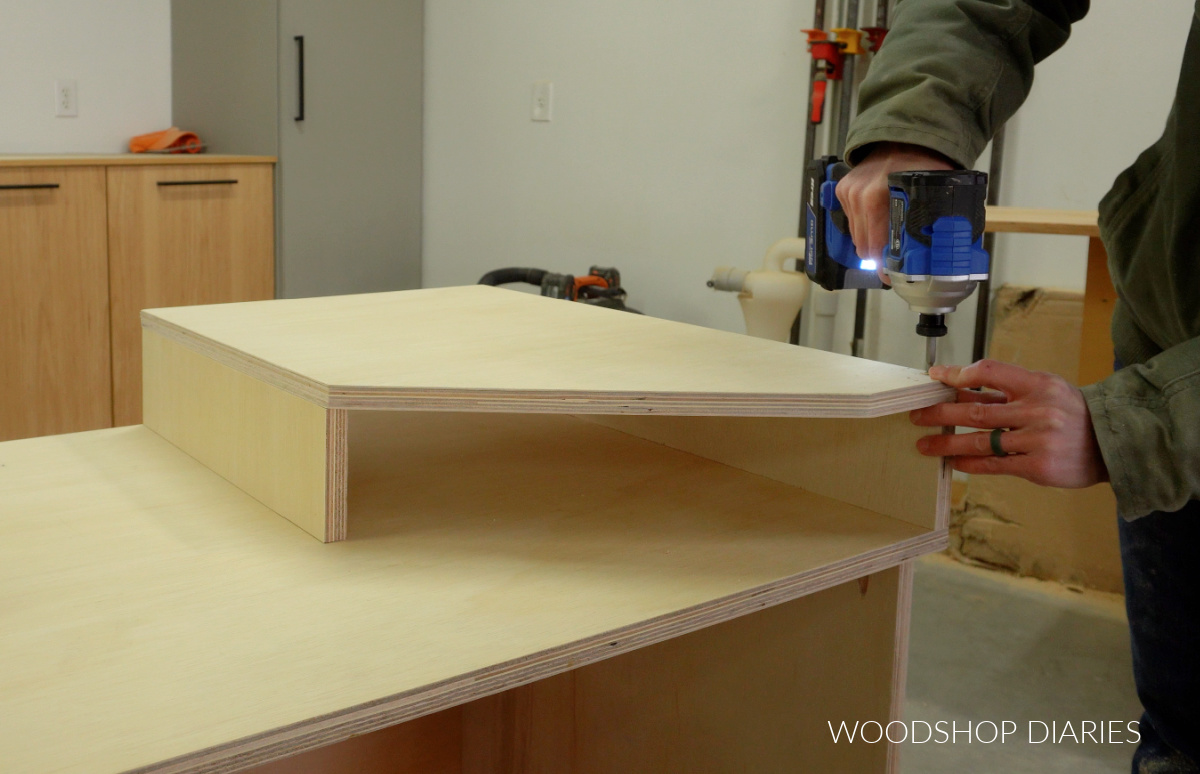 Shara Woodshop Diaries screwing top panels onto miter saw support risers
