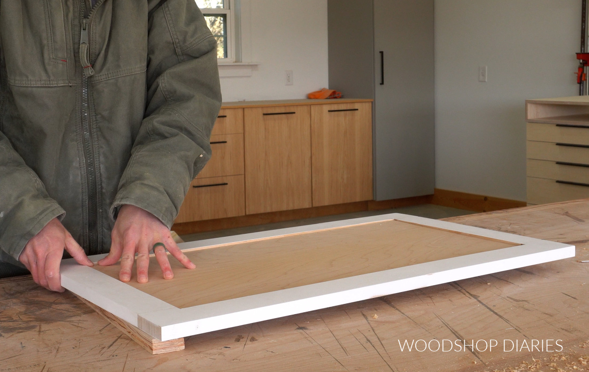 Shara Woodshop Diaries assembling cabinet door on workbench