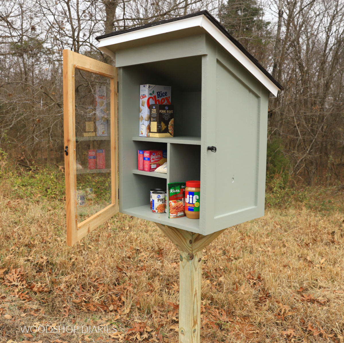 Completed DIY free little pantry installed onto post with door open and food inside