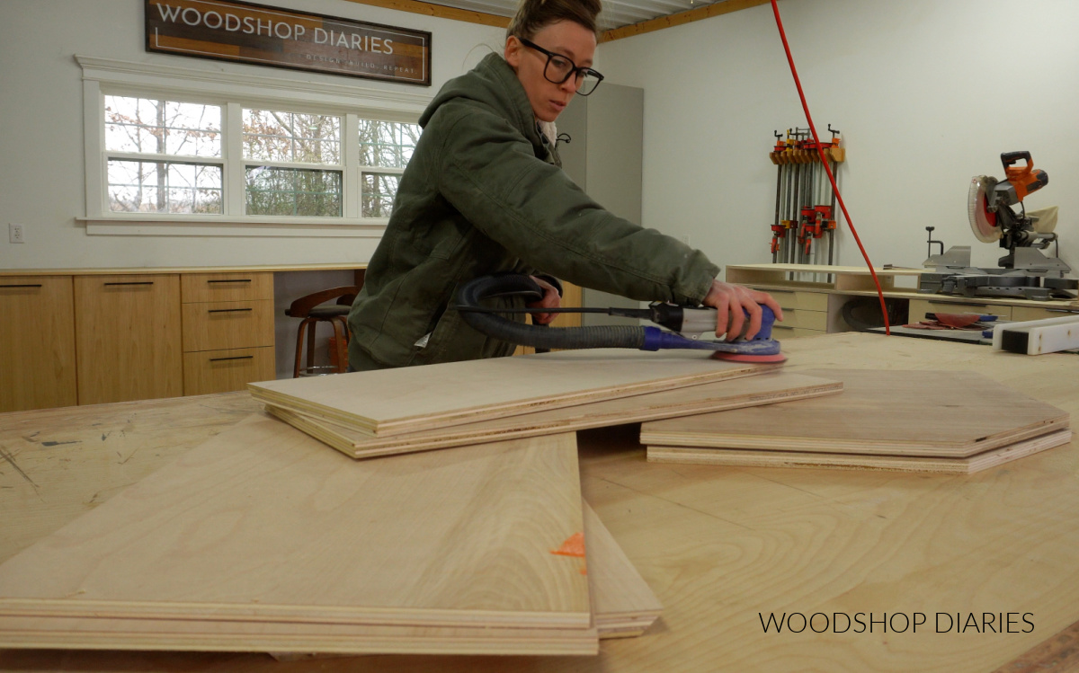 Shara Woodshop Diaries sanding plywood parts to assemble corner wall cabinet