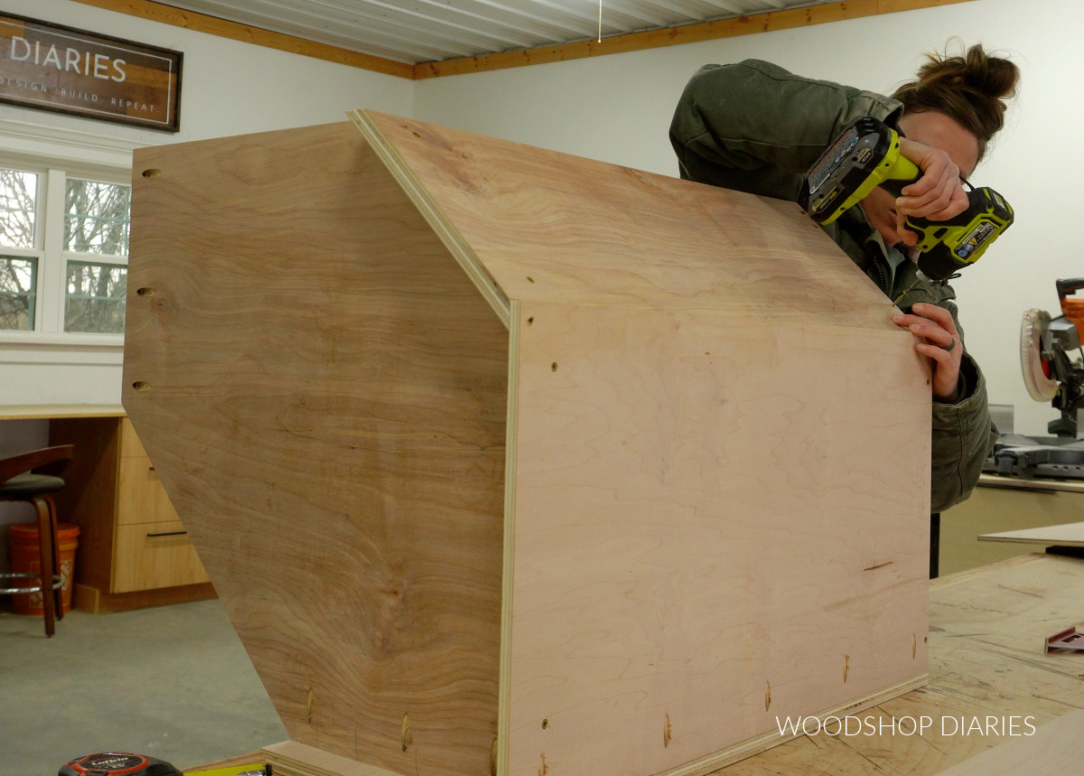 Shara Woodshop Diaries driving screws to assemble DIY corner cabinet box