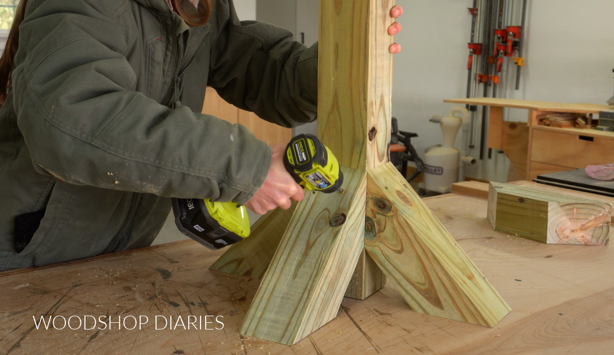 Shara Woodshop Diaries driving screws through 4x4 post supports on workbench