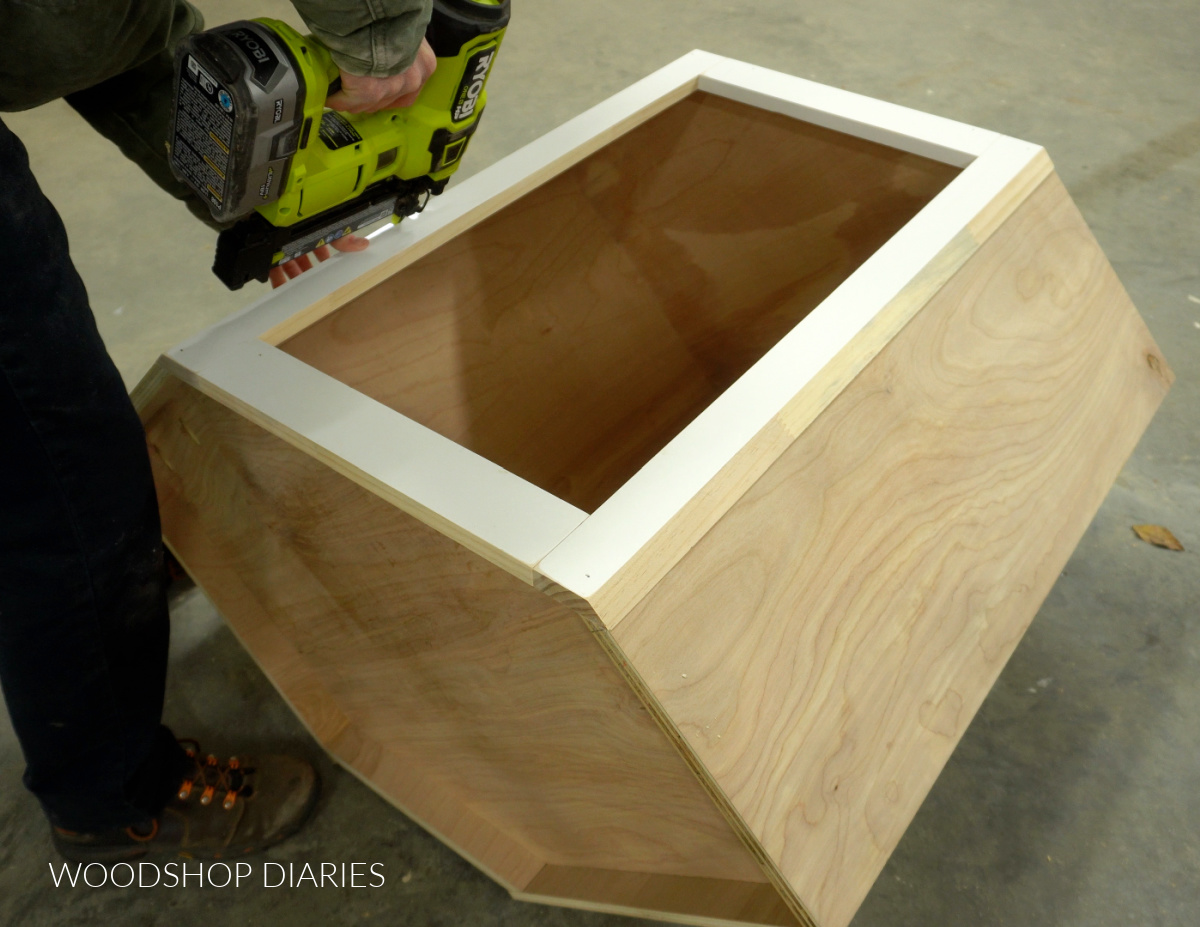 Shara Woodshop Diaries nailing face frame onto front of corner cabinet box