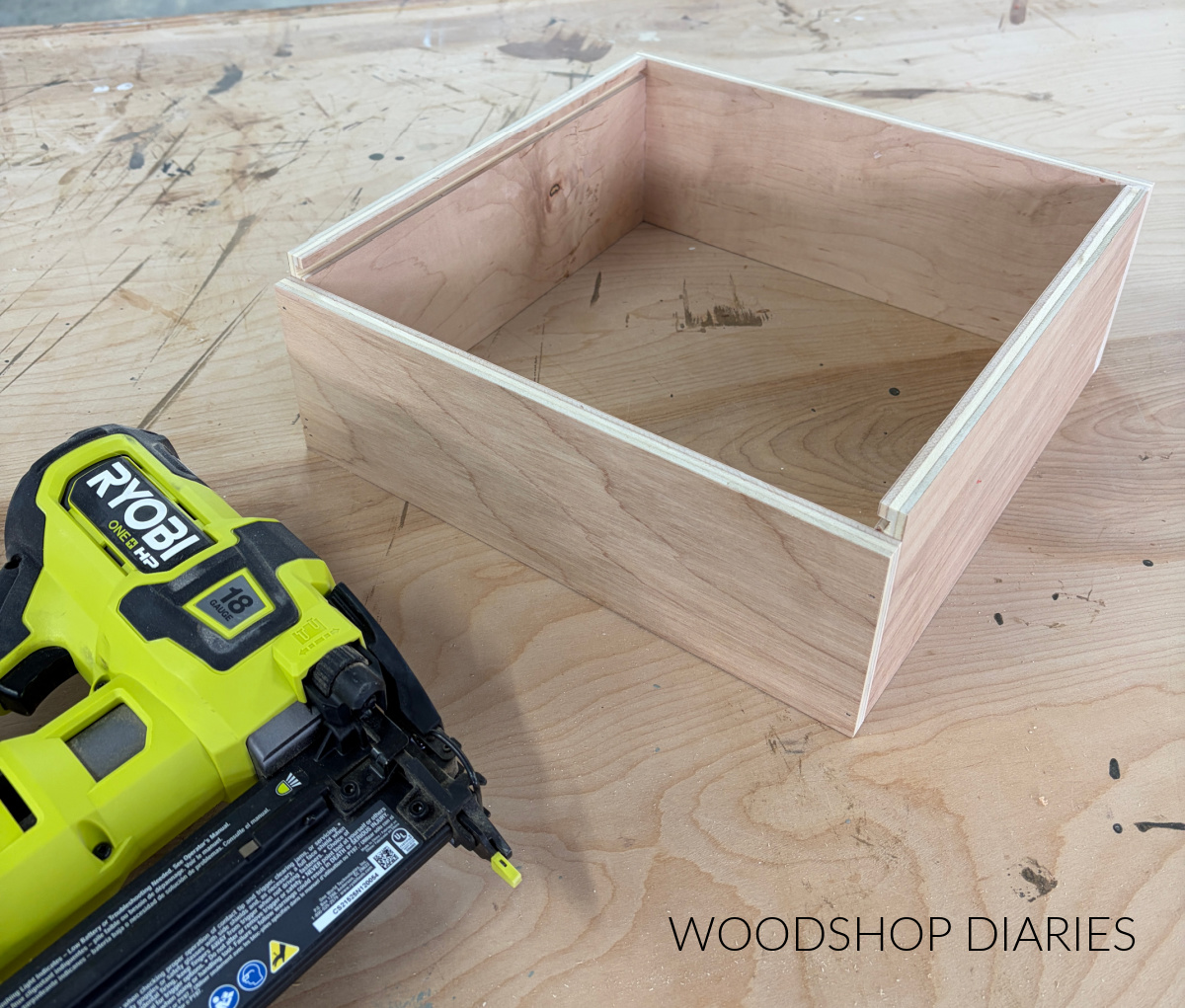 Wooden pie box sides assembled on workbench with brad nailer