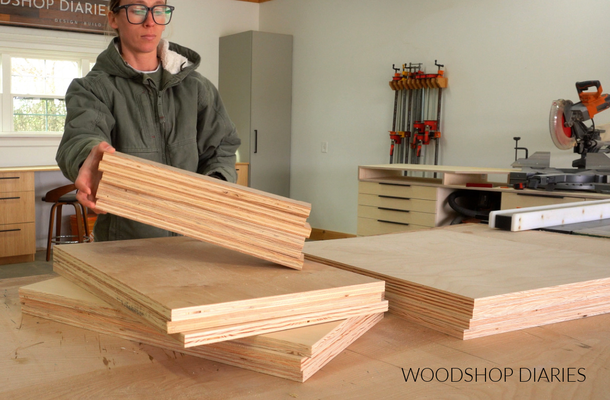 Shara Woodshop Diaries stacking plywood pieces on workbench