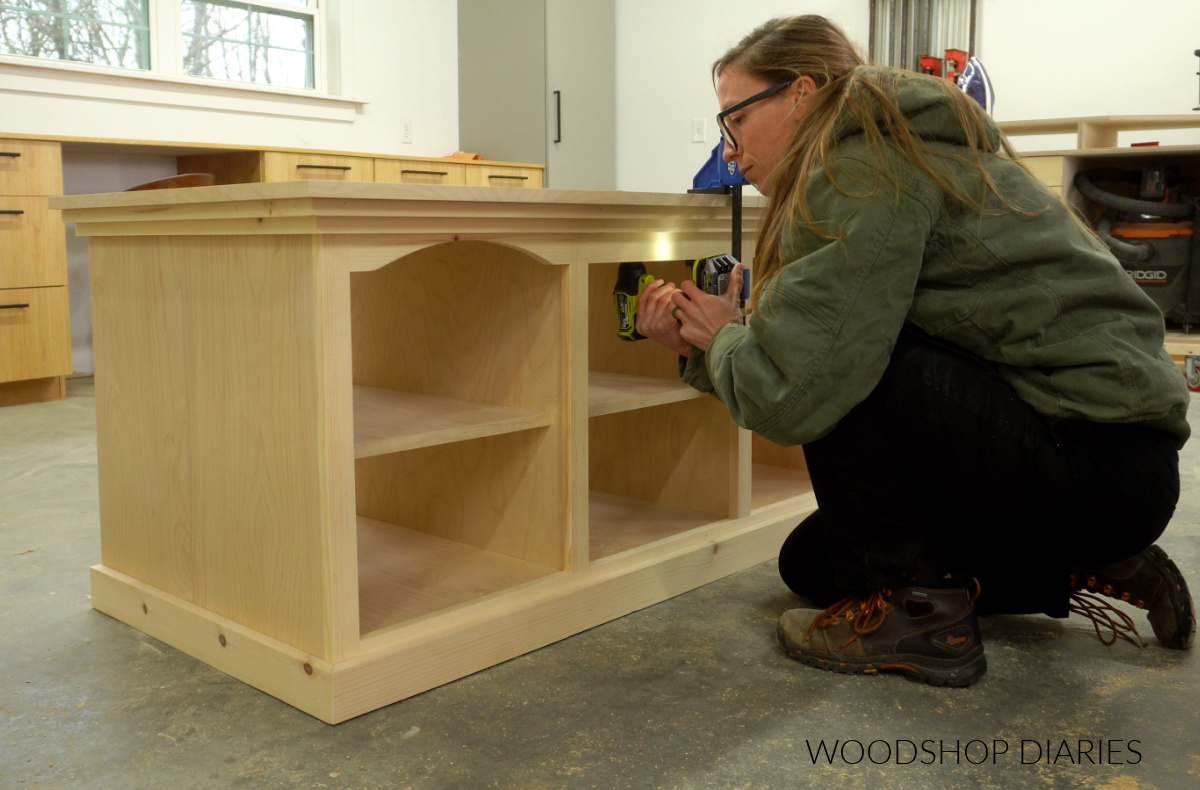 Shara Woodshop Diaries securing top panel of tv stand using screws