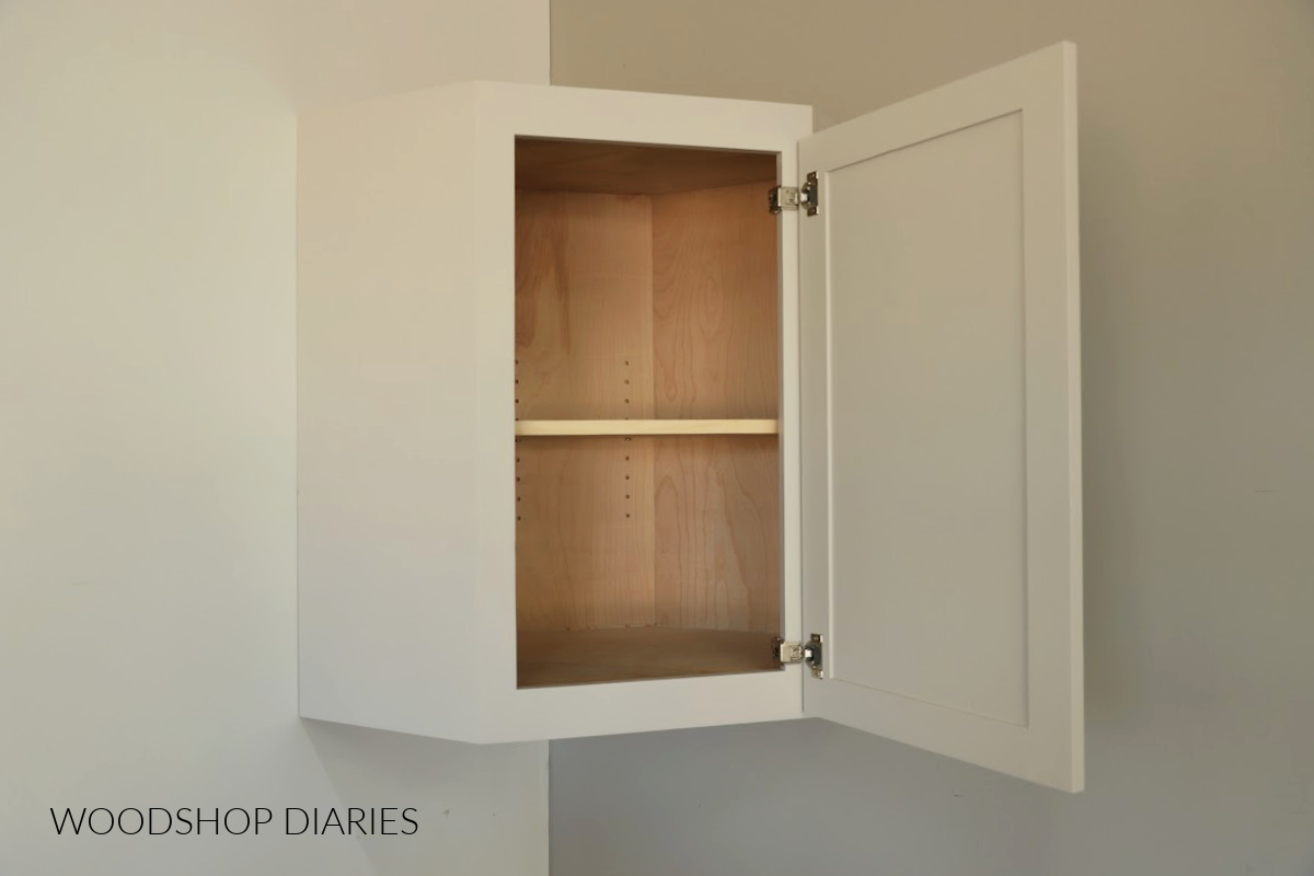 DIY corner wall cabinet hung on wall with shelf and door open