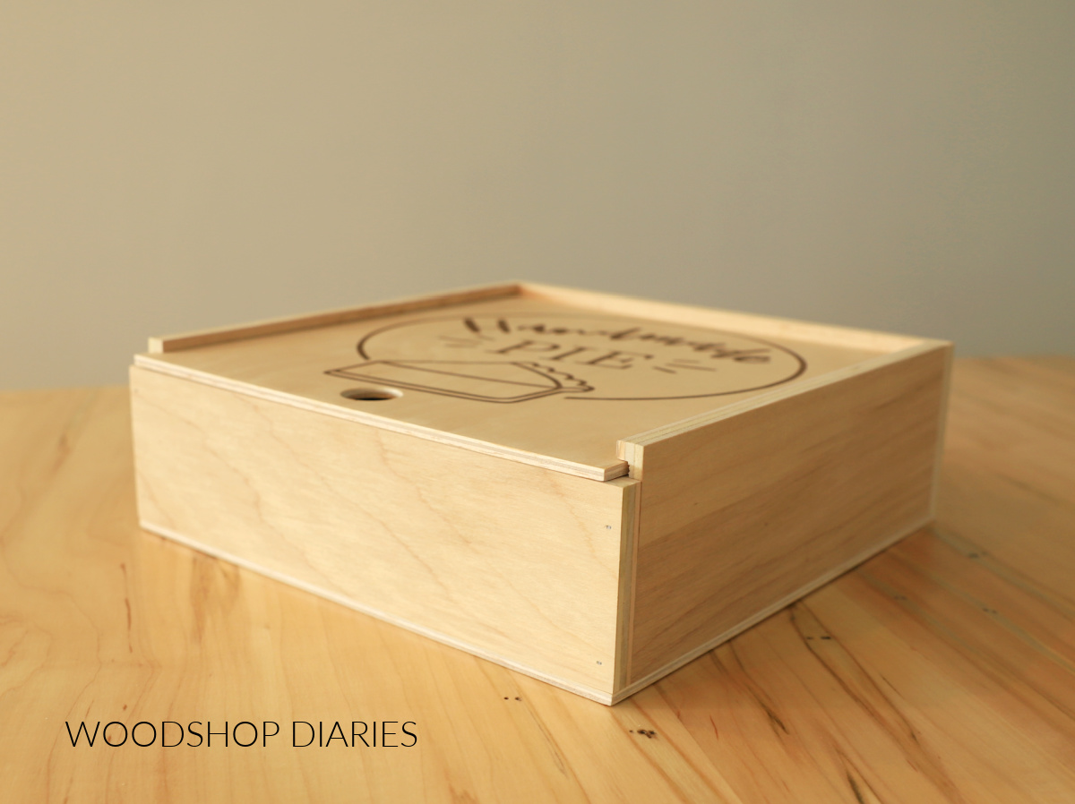 Completed wooden pie box with sliding lid closed on table