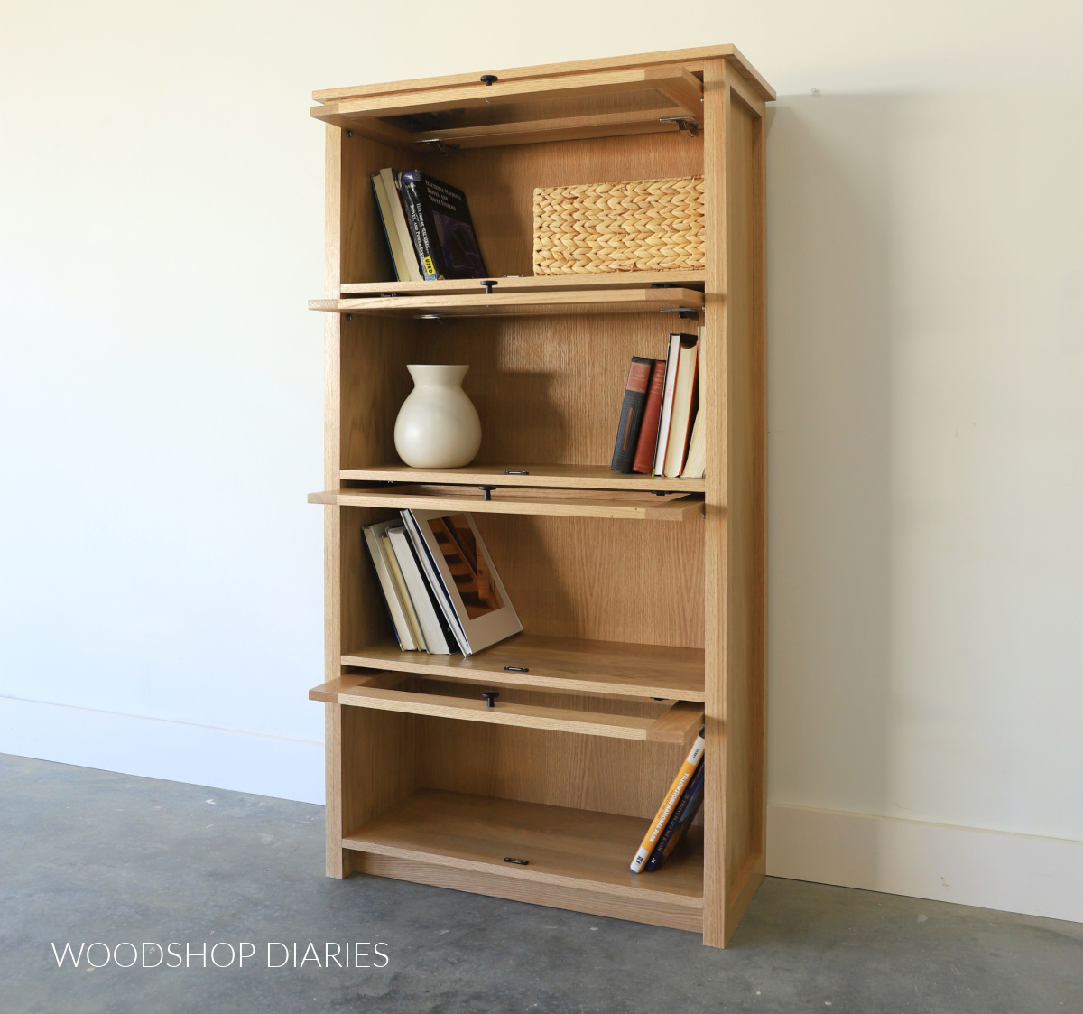 DIY red oak Barrister bookcase with four pocket doors opened revealing books inside