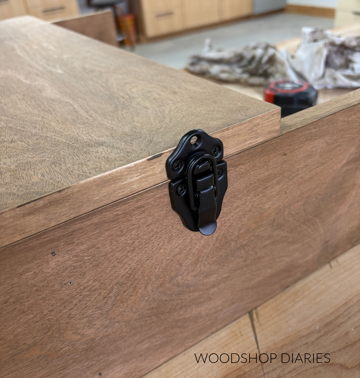 Close up of chest latch installed on side of murphy desk to hold door shut