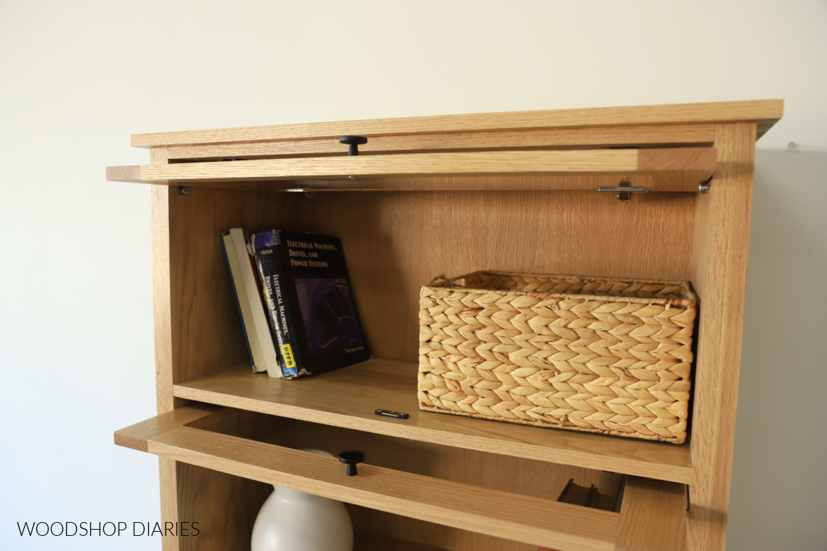 Close up of pocket door opened on DIY barrister bookcase showing door catch and bearings holding door in up position