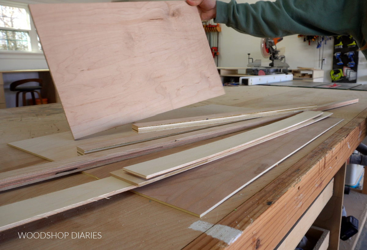 Stack of scrap plywood on workbench. Includes ¼", ½" and ¾" plywood