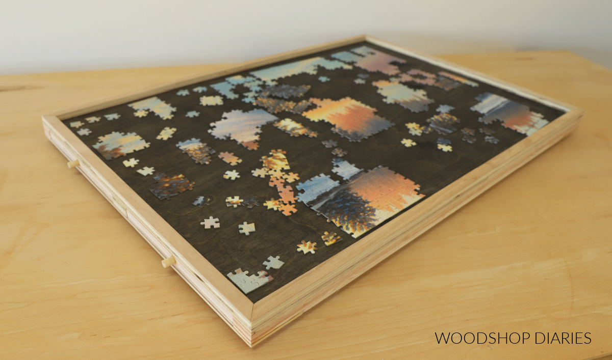 DIY Puzzle board with drawers closed. Puzzle started on top.