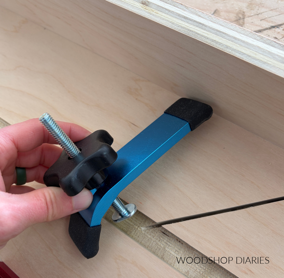 Closeup of t track clamps showing t track bolt lined up with t track slot