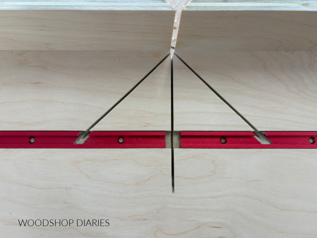 T tracks fit into slot of plywood jig with notches around the 45 degree kerfs