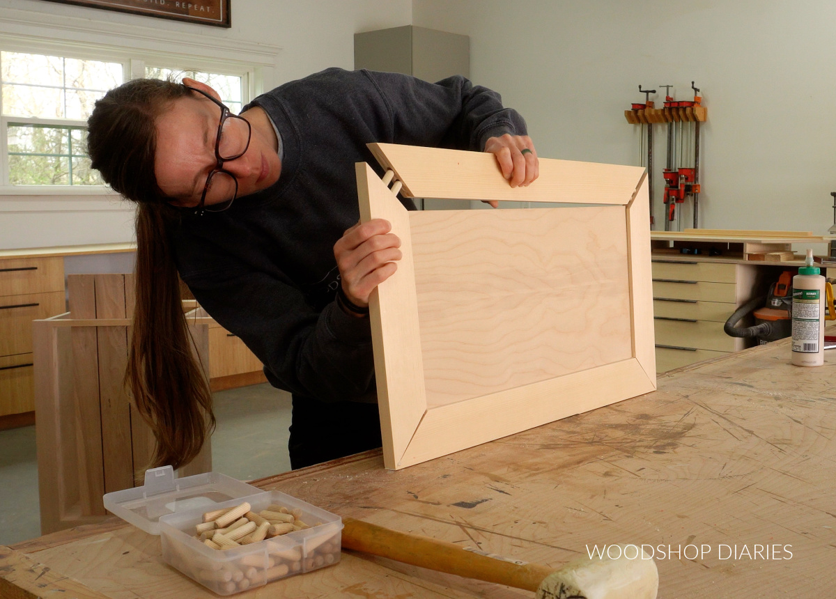 Shara Woodshop Diaries assembling door panels using dowels on mitered corners on workbench
