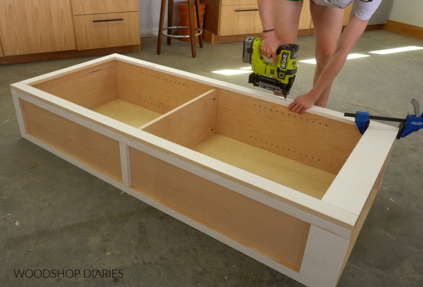 Shara Woodshop Diaries brad nailing face frame onto front of bookshelf