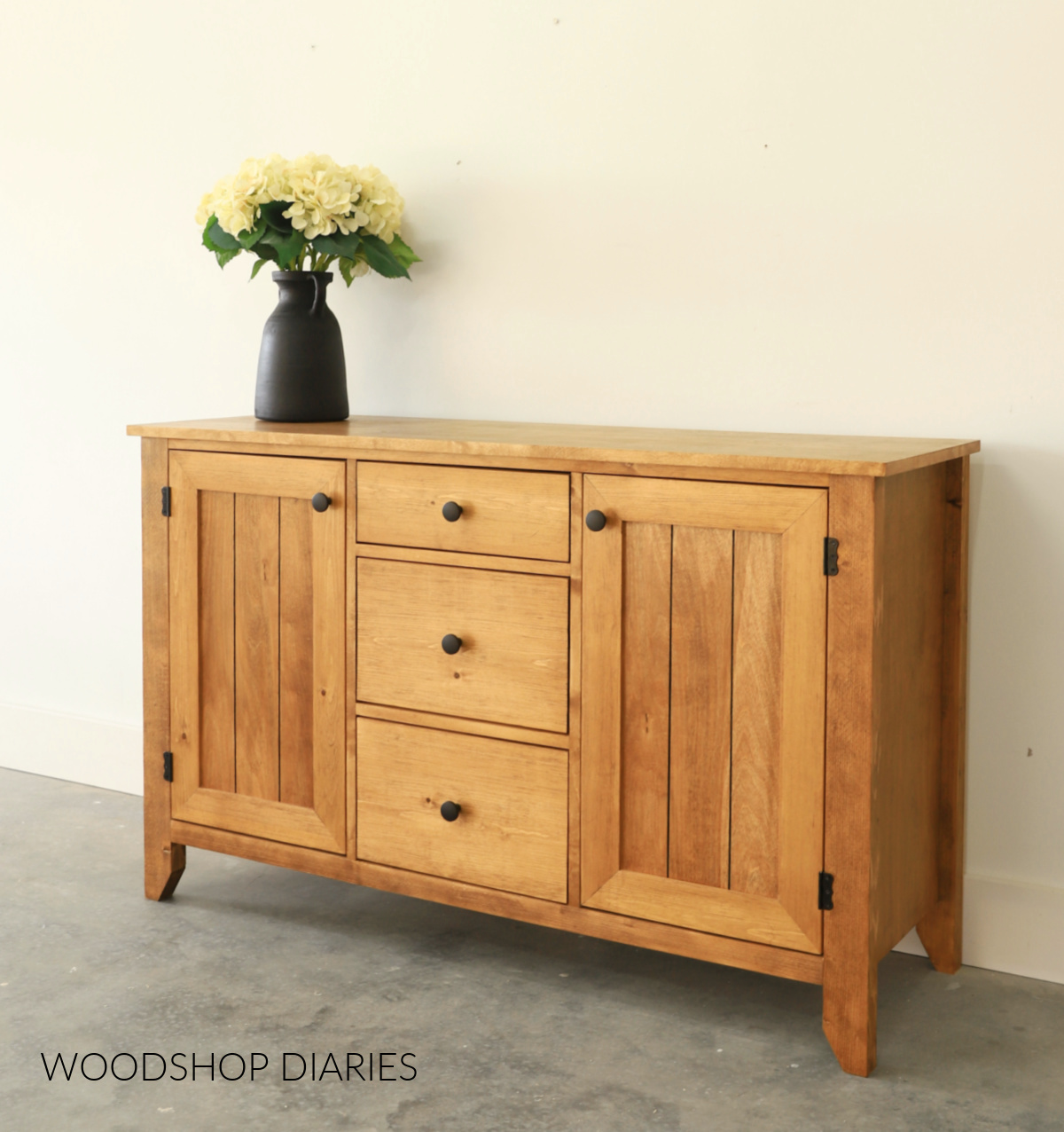 Wooden DIY buffet table with two doors and three drawers stained in Minwax Early American wood stain
