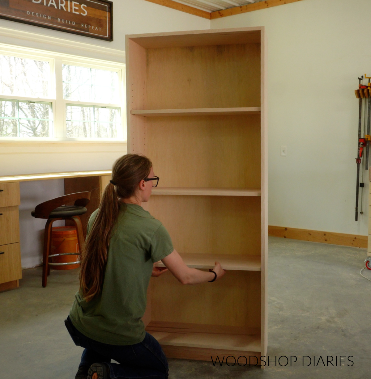 Shara Woodshop Diaries placing adjustable shelves into bookcase on shelf pins