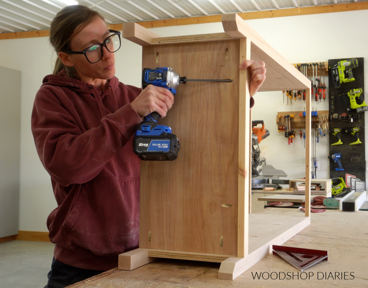 Shara Woodshop Diaries attaching bottom shelf of small bookcase using pocket holes on workbench