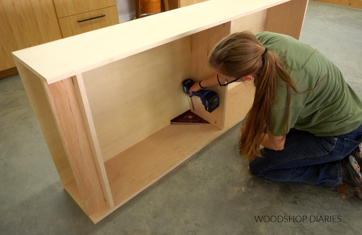 Shara Woodshop Diaries installing stationary shelf in middle of bookcase using pocket hole screws