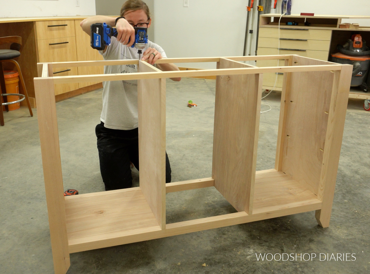 Shara Woodshop Diaries securing divider panels of console to top supports