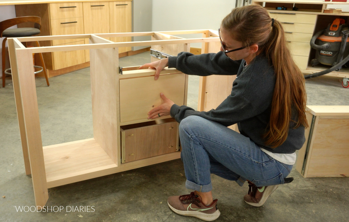 Shara Woodshop Diaries placing drawer fronts onto drawers in buffet table
