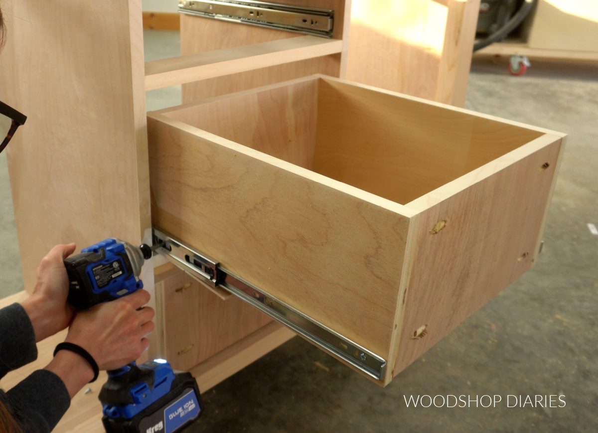 Shara Woodshop Diaries installing drawer box onto slides in buffet table cabinet