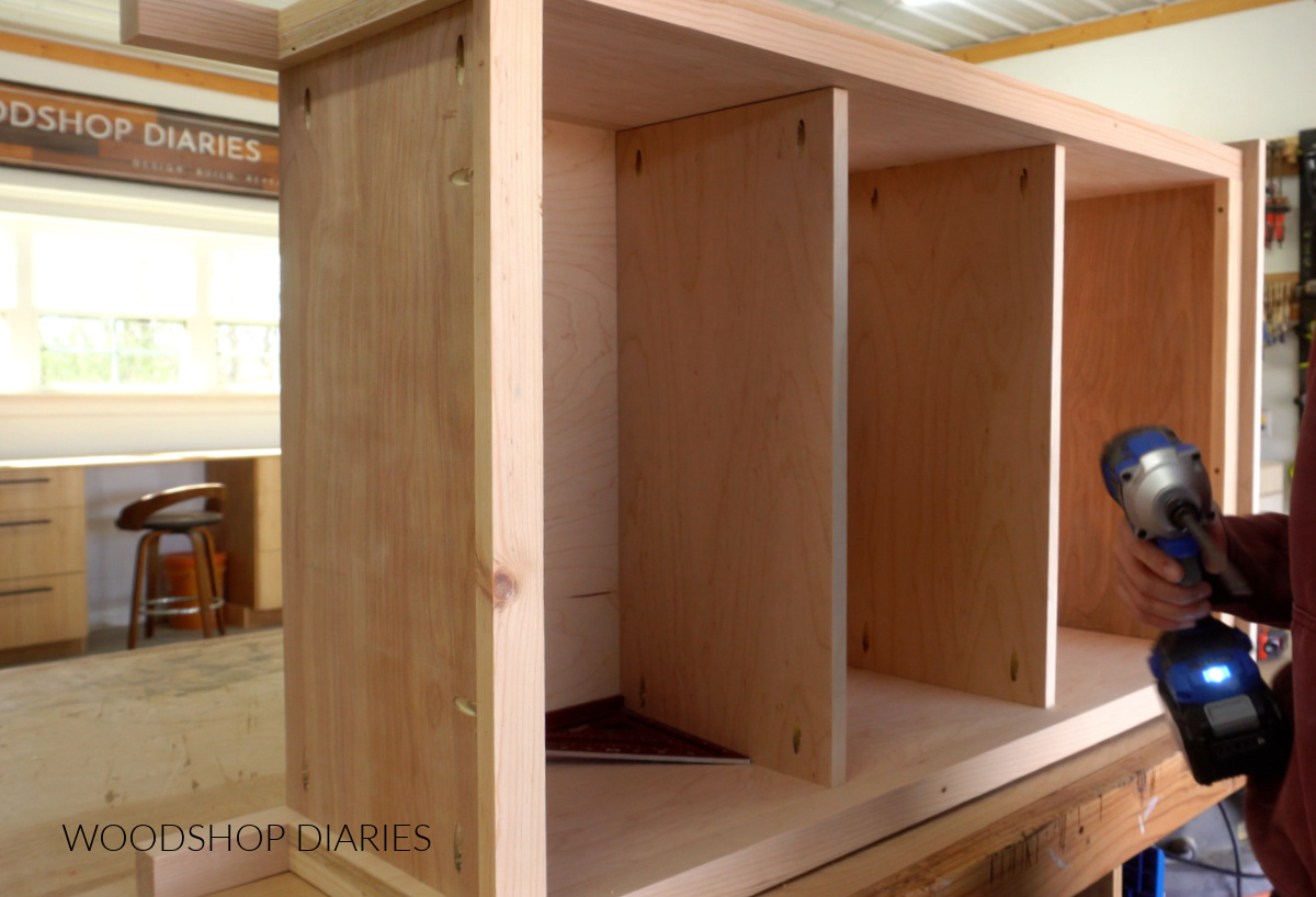 Two stationary shelves installed into bookcase with pocket holes on workbench