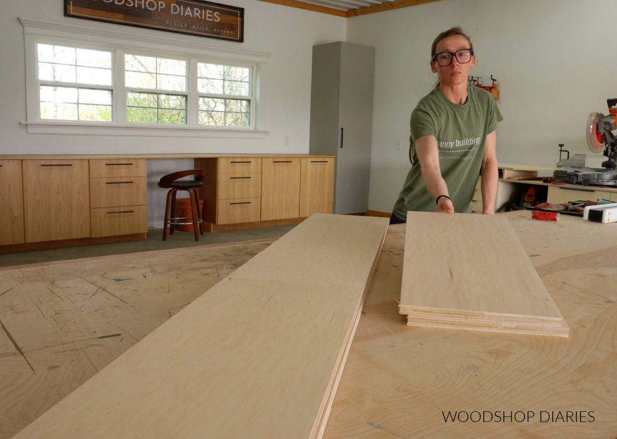 Shara Woodshop Diaries placing plywood pieces on workbench to build bookshelf