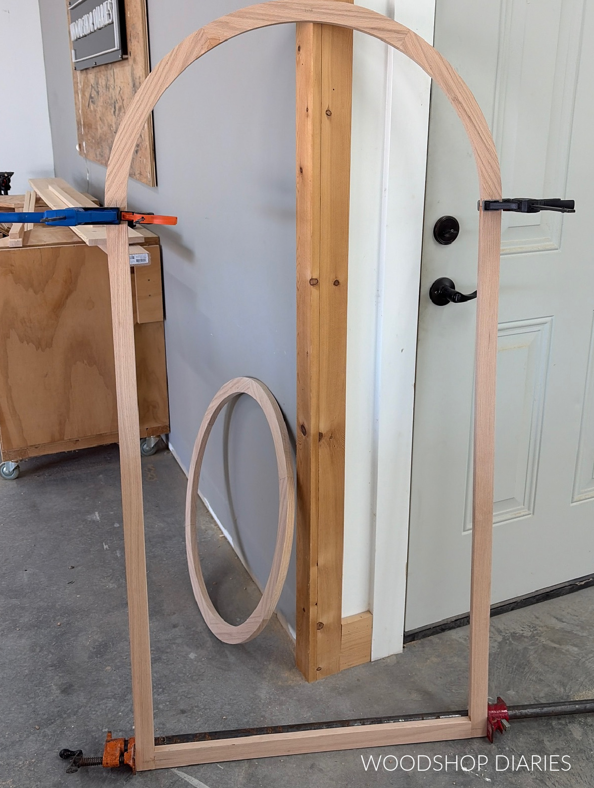 Arched top cabinet face frame glued up leaning against wall