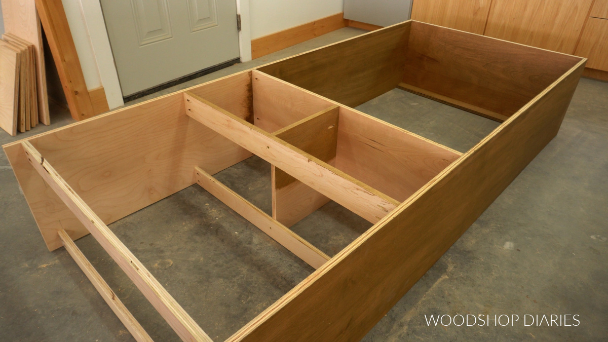 Closet tower cabinet assembled with dividers for drawer boxes in bottom section