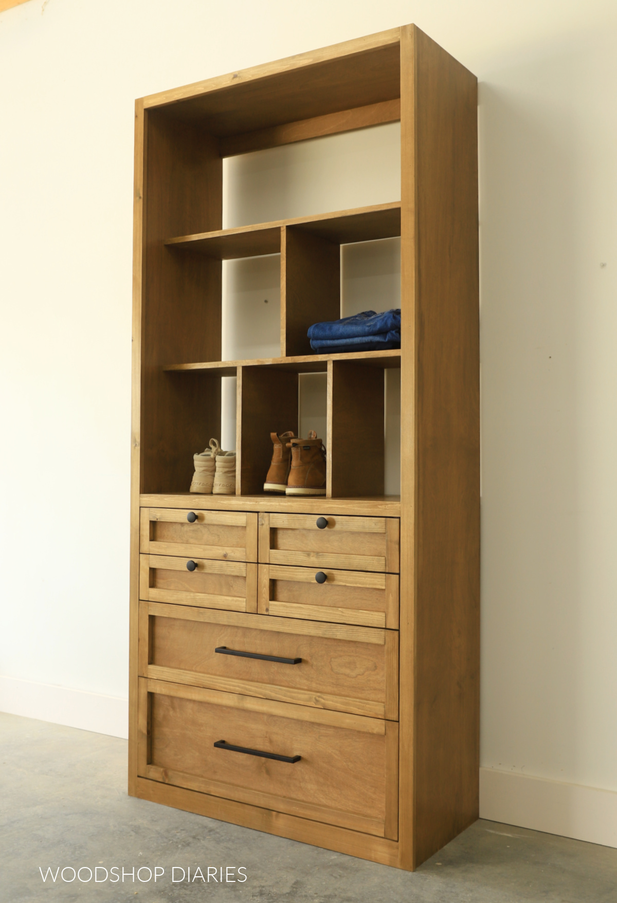 Finished DIY closet tower with six various sized drawers at the bottom and shelving with dividers at the top