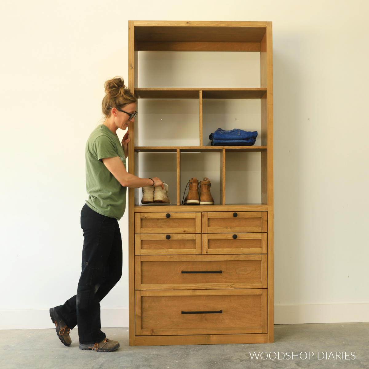 Shara Woodshop Diaries placing shoes in closet tower with drawers and shelving