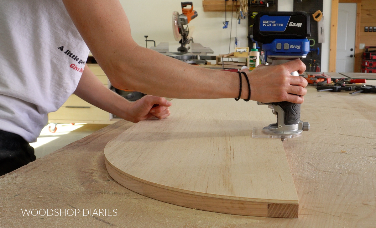 Close up using router to flush cut plywood to the edge of arched door frame