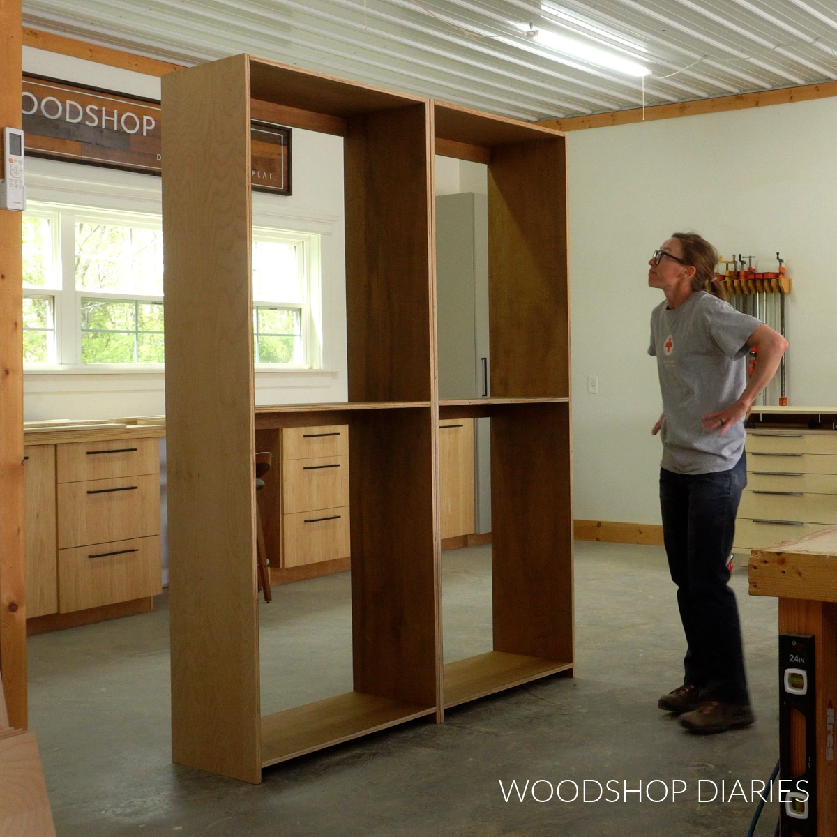 Shara Woodshop Diaries looking at two large identical closet cabinets assembled in workshop