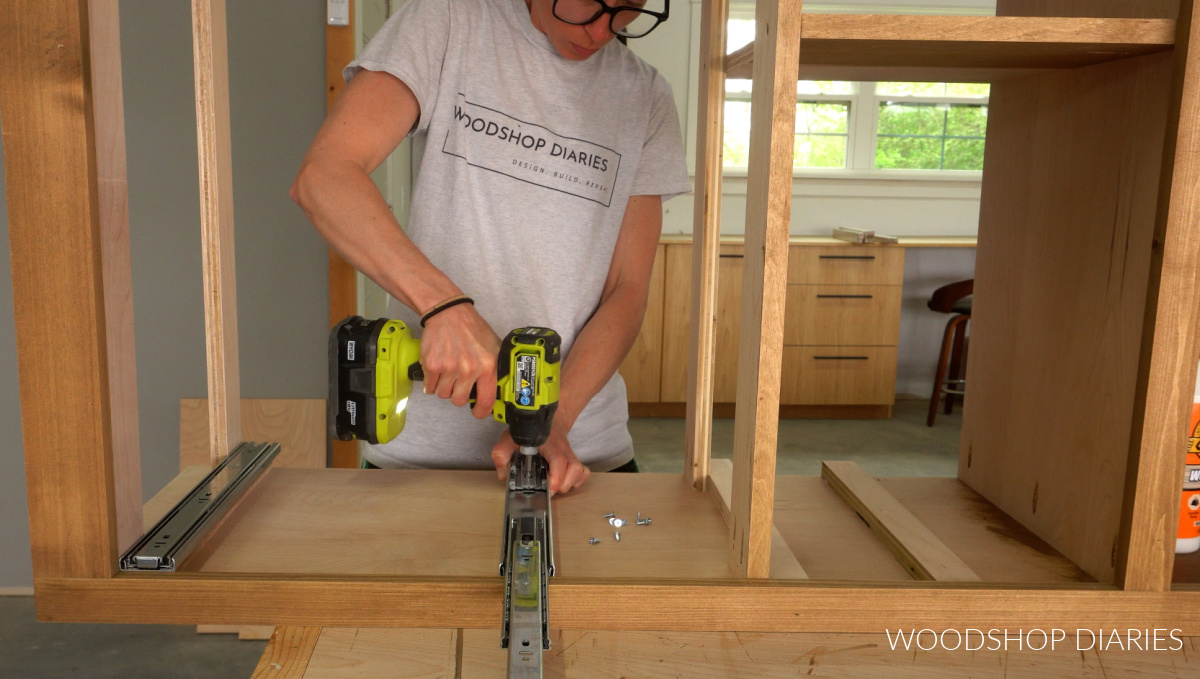 Shara Woodshop Diaries installing drawer slides onto spacer closets in cabinet with face frame