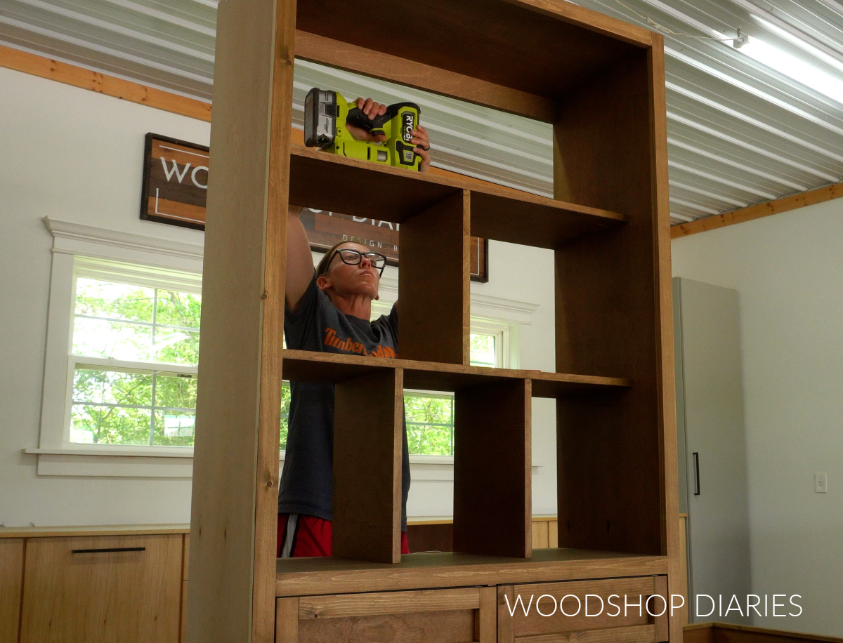 Shara Woodshop Diaries installing dividers into shelving at top of closet cabinet in workshop