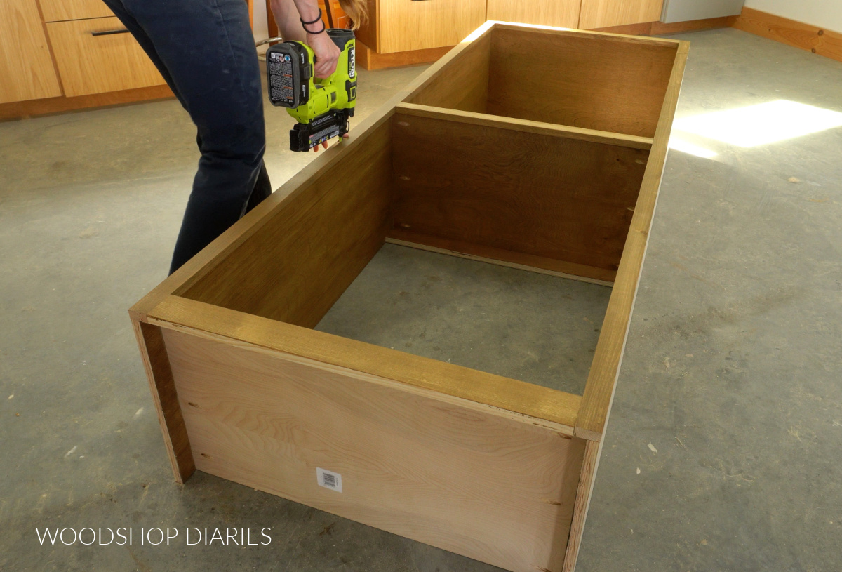 Shara Woodshop Diaries gluing and nailing face frame onto front of cabinet box on workshop floor