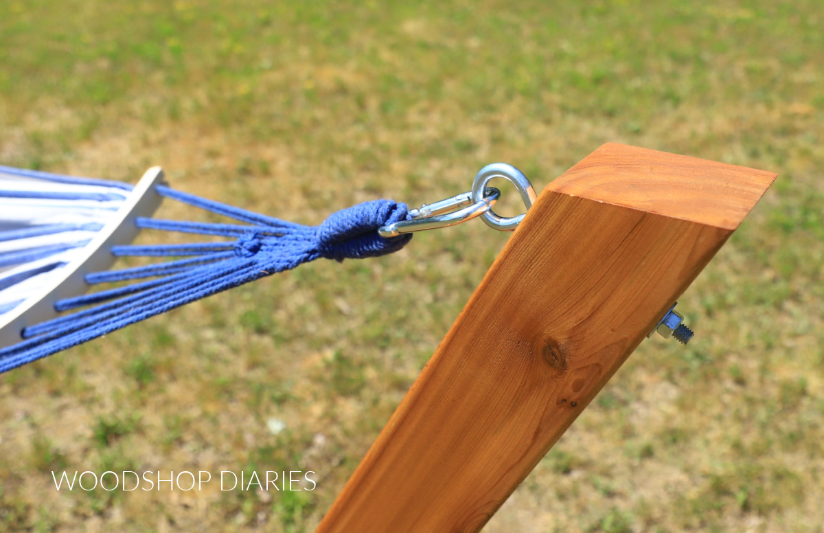 Close up of hammock clipped on eye bolt with carabiner clips on DIY hammock stand