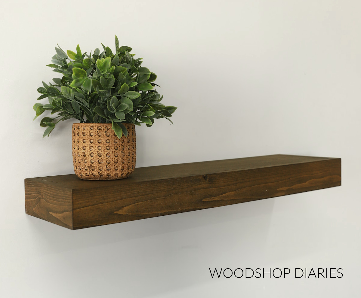 brown stained DIY wooden floating shelf with plant