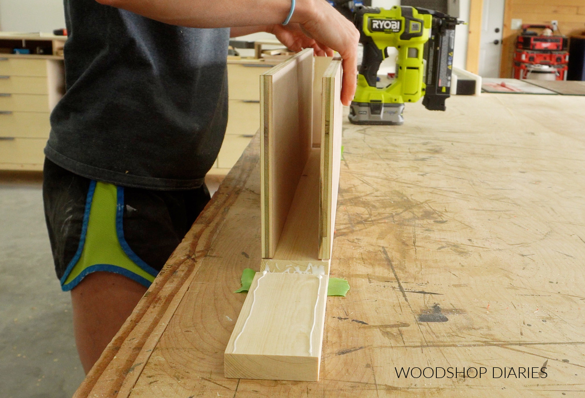 Shara Woodshop Diaries assembling floating shelf box using wood glue on workbench