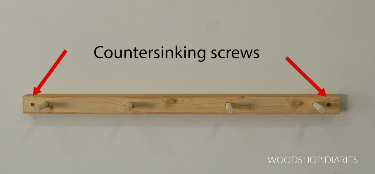 Back of shelf board with dowels installed into wall studs